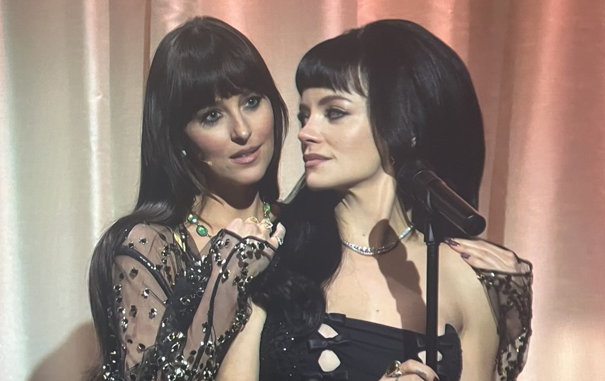 PopCrave's tweet image. Dakota Johnson plays Madeline during Lily Allen’s SNL performance of “Madeline.”