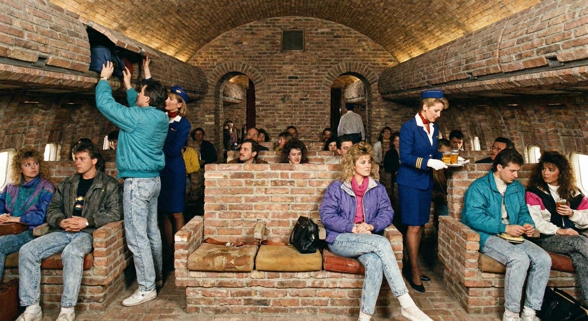 photo from the 1980s of the interior of an extremely large commercial plane, with people boarding and sitting down, and a couple flight attendants throughout the cabin. however, the plane is made out of brick
(nano banana pro)