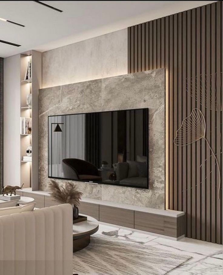 جدار شاشة جميل تم فيه استخدام التكسية الخشبية
وبديل الرخام مع الارفف
وطاولة خشبية.
لتنفيذ أعمال مشابهة
ديكوريزما للديكور جدة دوار الهندسة