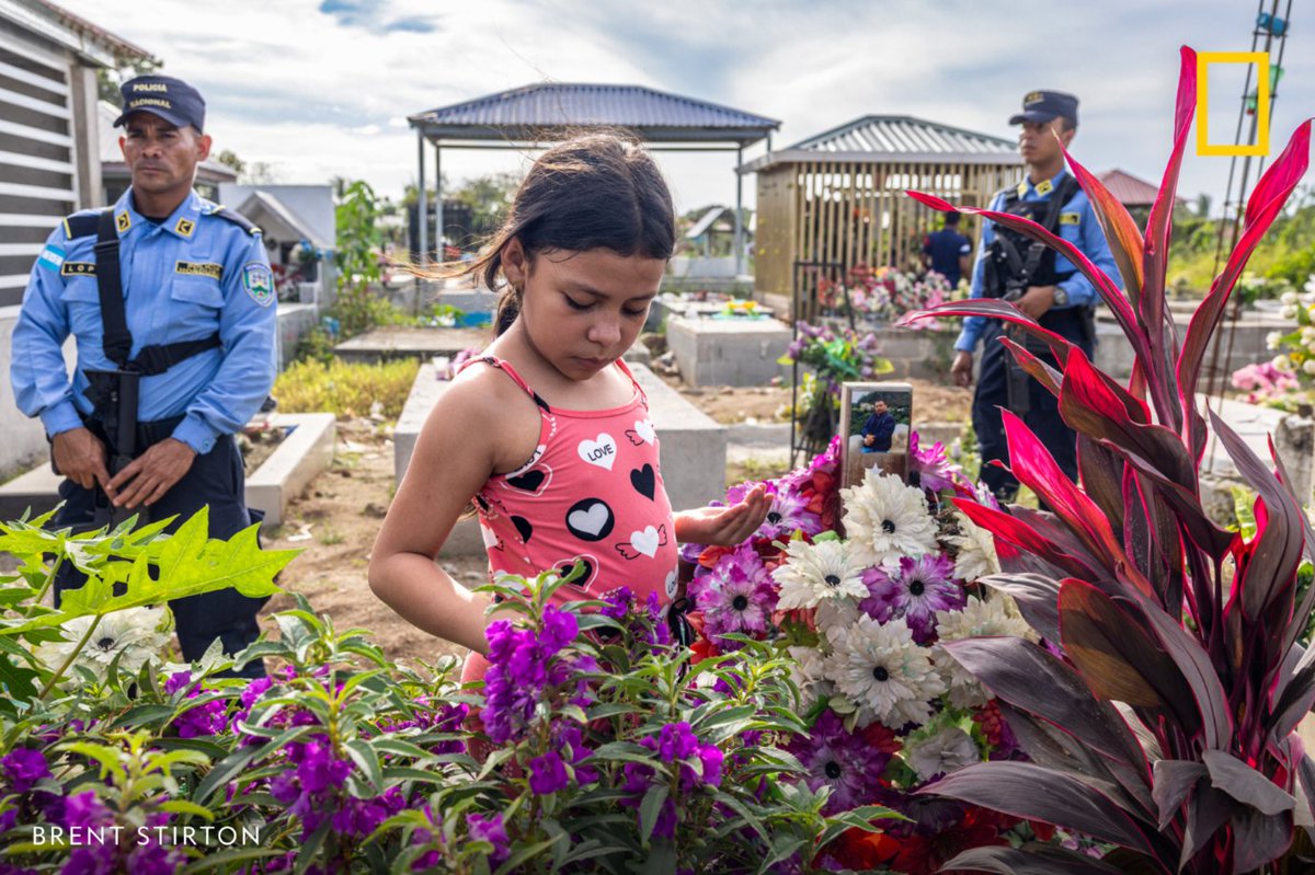 In this image from our Pictures of the Year 2025, Nat Geo Explorer and photographer Brent Stirton photographed nine-year-old Julia López's visit to her father's grave in Tocoa, Honduras. Juan López was one of 18 known climate defenders killed in the country last year.