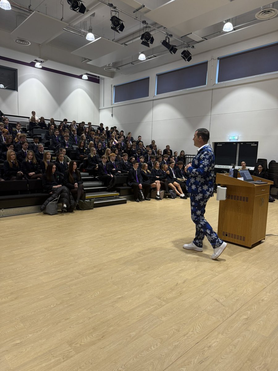 hallmead's tweet photo. A serious Year 11 assembly this morning in advance of results and predicted grades being published tomorrow. 

The message was delivered in a Christmassy way though by Mr Leslie! 

Day 1 of his 5 Christmas suits 🎄🎄🎄🎄

@elatrust @HallMeadPastor1 @MattDronfield https://t.co/ebuoRyU8TL