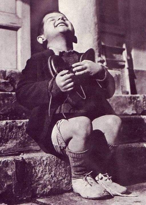 HistoryUnd's tweet image. Boy receiving a new pair of shoes at an orphanage in Austria, 1946.