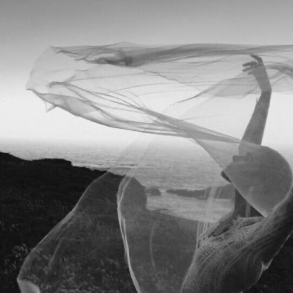 She is a wind chime,
heart shaped
bells of glass crystals
suspended by thin
filaments of raw silk.

He is a windstorm
blowing gusts of shadows
and billows of thin air
upon her music.

His subtle turbulence whirls
  beneath her
  around her 
  through her
And never touches her