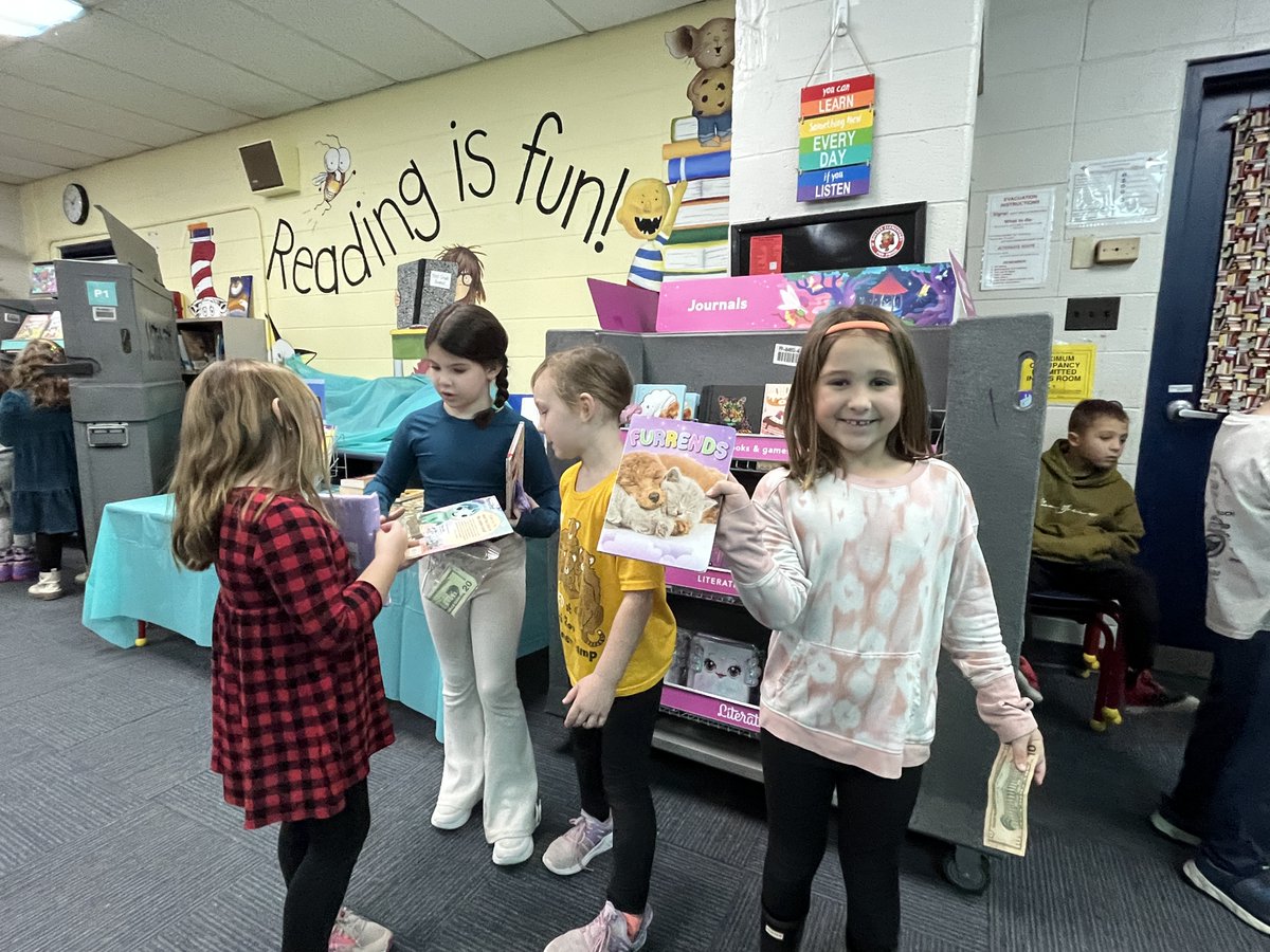 OHLSD's tweet photo. The students at J.F. Dulles Elementary had their Book Fair last week and first graders in Amelia Eger's class had fun picking out and buying their favorite books! You can see how happy these young readers are by the big smiles on their faces! #ThePowerOfReading https://t.co/GCrEydlXce