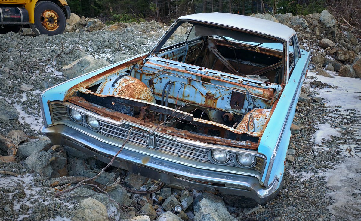 1966 Chrysler Newport.  Look to have been left in the woods and now they're clearing the land for a couple of building lots.  Car itself is in pretty good shape.  Someone needs to save this and murder it out.