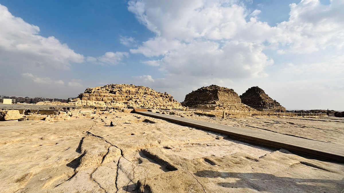 Amrita_Chakra's tweet photo. The complex housing the Great Pyramids of Giza in Egypt is rich with 5,000 years of recorded and unrecorded history. In Giza, which is on the outskirts of the Capital City of Cairo, we can primarily see three huge pyramids - the first is by King Khufu, the second one is by King Khafre, and the relatively smaller one by King Menkaure.
King Khufu constructed three more pyramids adjacent to his own - for his wife, his mother, and his daughter respectively. Egyptologists contend that there are around 118 to 125 smaller pyramids in area adjacent to the Great Pyramids. 
King Khufu was instrumental in developing the legendary Egyptian mechanism to preserve people’s bodies after death. The massive nature of each of the pyramids proves that the ancient Egyptian kings had enough resources and wealth. King Khufu’s son King Khafre’s pyramid is the second biggest in size. During his 23-year-long rule, he not only constructed his own pyramid but also the Great Sphinx. His son King Menkaure constructed the last giant pyramid. King Menkaure was spiritual in nature and modelled himself as the son of the Sun God ‘Ra.’ He, thus, constructed a temple for worshipping the Sun God, which is bigger than his own pyramid. He died leaving his pyramid unfinished that was eventually completed by his son Shepseskaf.

#traveldiaries #pyramids #egypt #amritachakraborty