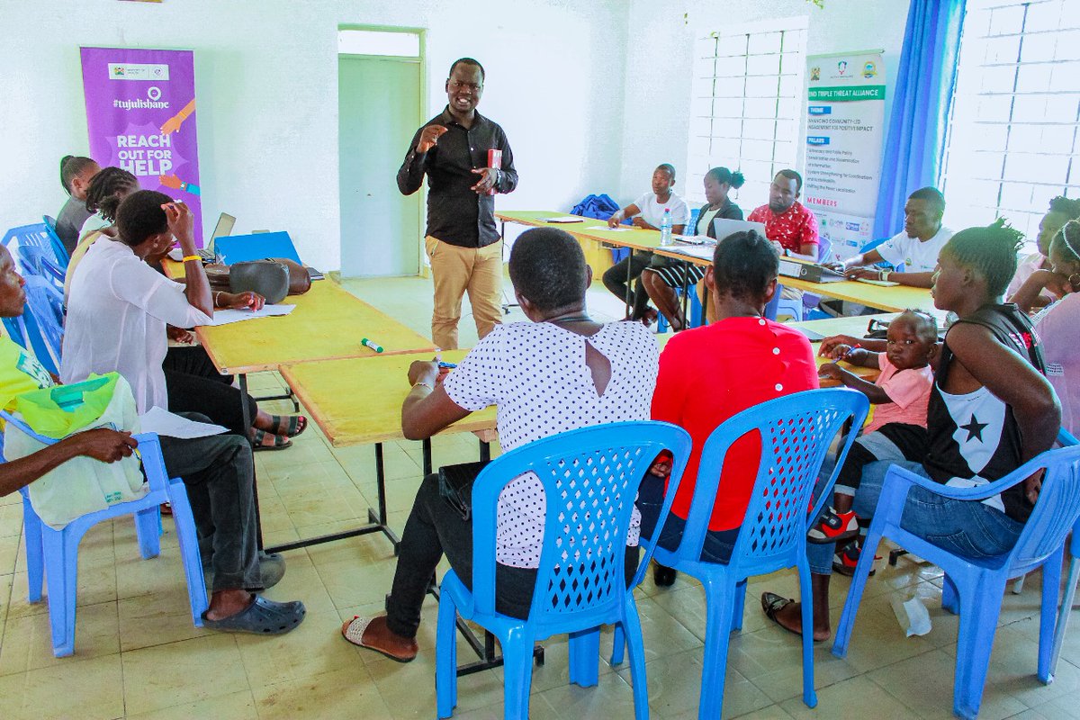 Leadership that listens and inspires. The Executive Director engaging TIKO mobilisers during an interactive session.