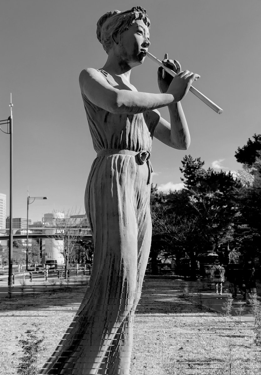 Statue of a Maiden Playing a Flute