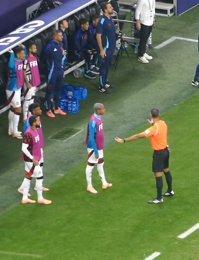 الحكم الرابع أمين عمر يقوم بتهدأ دكة بدلاء فلامنجو بسبب الاعتراضات على عدم احتساب ركلة جزاء لفريقهم أمام باريس سان جيرمان 