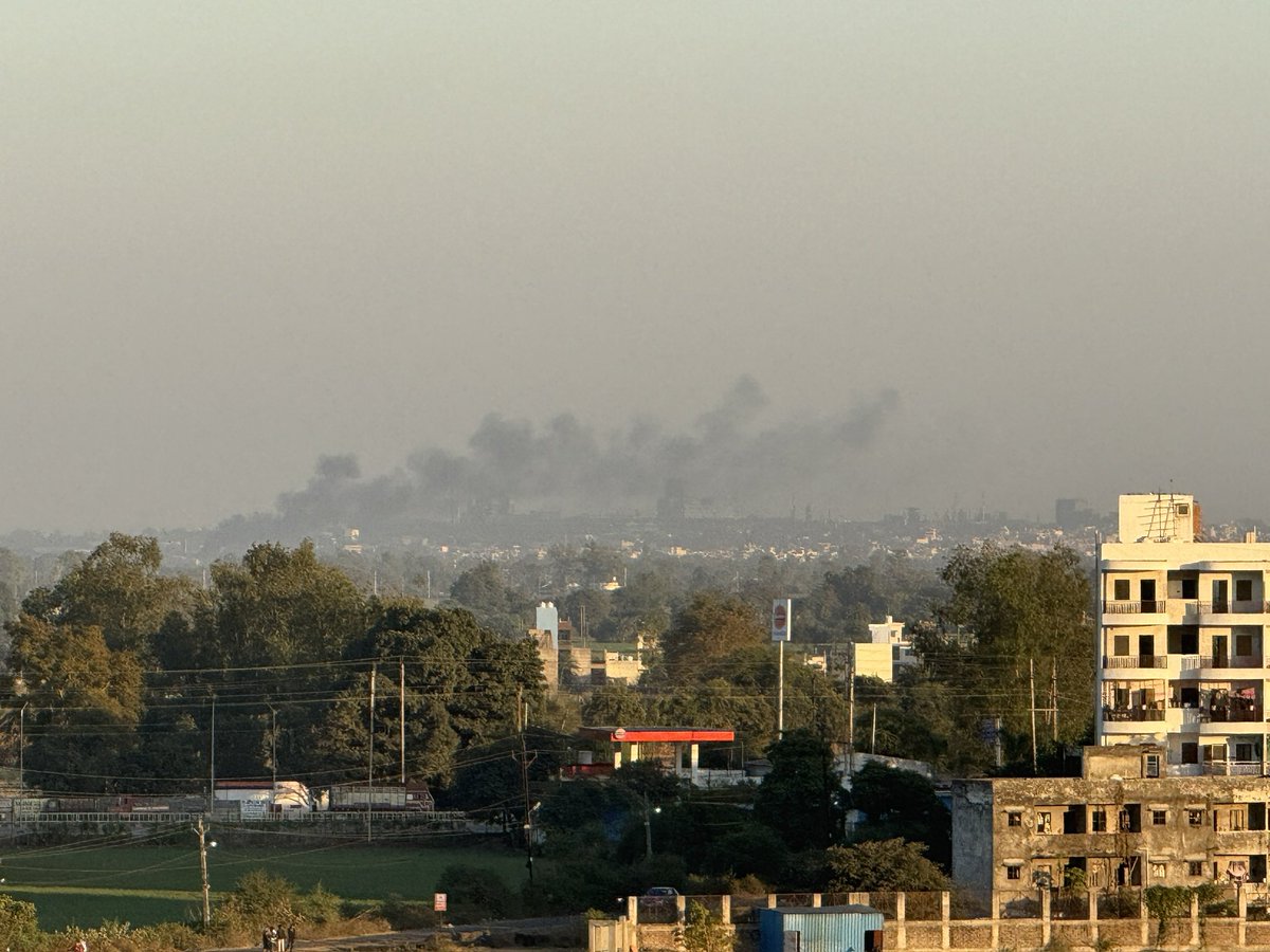 dhanv's tweet image. There is a heavy, beautiful truth in the way the horizon exhales. Beneath the soft veil of the afternoon haze, the world doesn’t just exist, it breathes. As the golden light drapes over the wild green and the weathered concrete alike, we are reminded that every lived-in corner of…