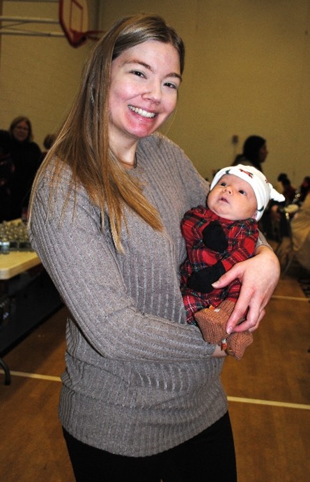 “The Spirit of Christmas is All Over this Party”

Aid for Women hosted its Annual Client Christmas party Saturday in the gymnasium of the lovely Monsignor Thiele Center of St. Aloysius Parish. Aid for Women staff and volunteers came early to design a festive Winter Wonderland for