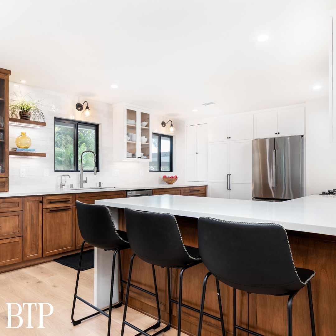 Warm wood cabinets paired with crisp white quartz countertops and durable vinyl flooring for a timeless, modern kitchen.