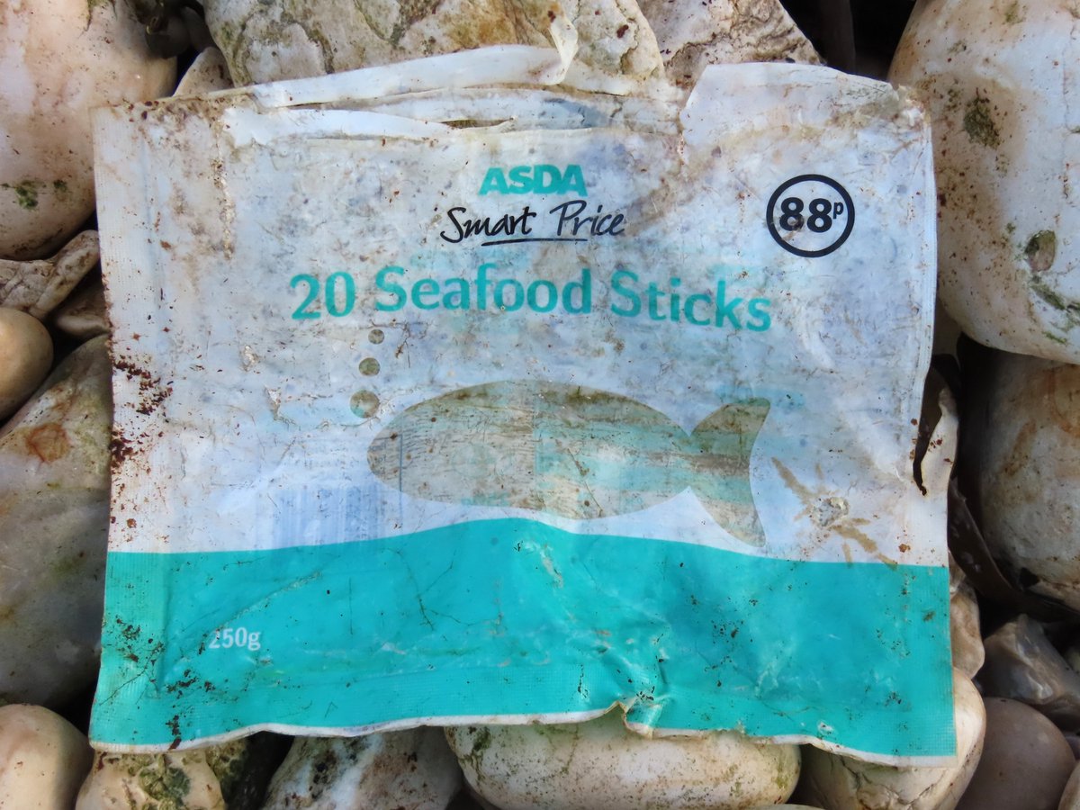 _Stickybeak's tweet photo. More bits of long-lived litter from a #2minutebeachclean - a discarded crisp packet folded into a triangle turned out to be Tayto Rollers from 2009. Also old-style Asda Smart Price packaging  that dates to some time between 2004 and 2012  #WashedUpOnRathlin #vintagelitter https://t.co/HsIuDMHqi7