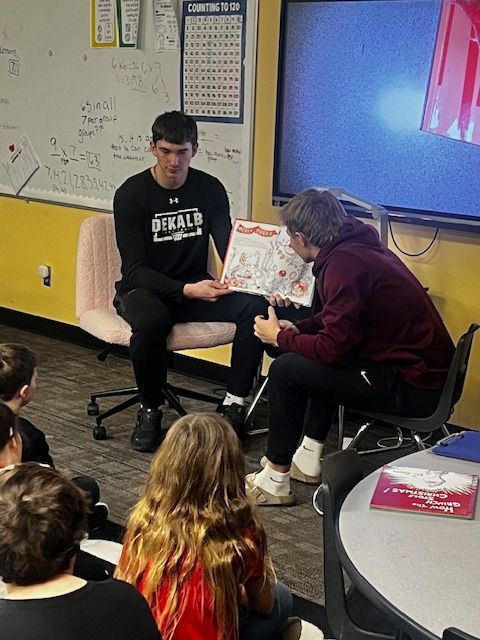 DeKalbHS's tweet photo. Shoutout to Graden Pepple and Caden Rice from the DHS Boys' Basketball Team! They read How the Grinch Stole Christmas, answered questions, and surprised students with autographs in Mrs. Ervin’s class by kicking off Grinch Day at Waterloo Elementary.🎄🏀 https://t.co/J2M2T5O6K8