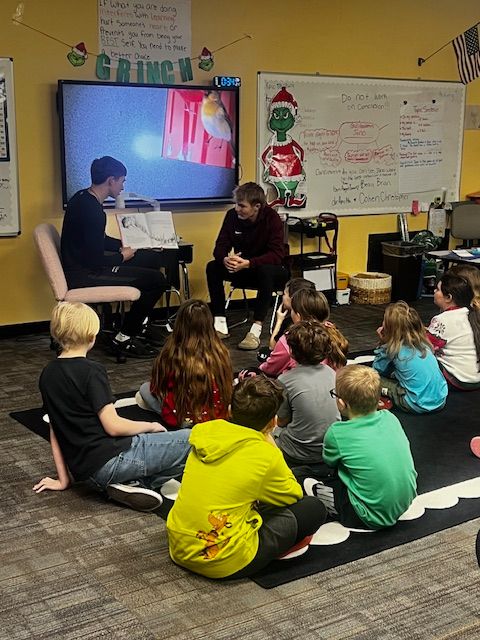 DeKalbHS's tweet photo. Shoutout to Graden Pepple and Caden Rice from the DHS Boys' Basketball Team! They read How the Grinch Stole Christmas, answered questions, and surprised students with autographs in Mrs. Ervin’s class by kicking off Grinch Day at Waterloo Elementary.🎄🏀 https://t.co/J2M2T5O6K8