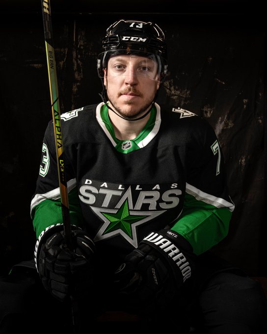 Adam Erne poses with a stick in the locker room in the ‘99 jersey