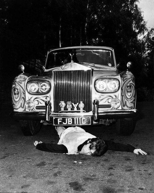 crockpics's tweet image. John Lennon, pretending to have been run over by his psychedelic Rolls-Royce, May 25, 1967 . Lennon ordered the  car in December 1964, and it was delivered the following June, originally painted matte black. In 1967, he decided to have it repainted bright yellow and commissioned…