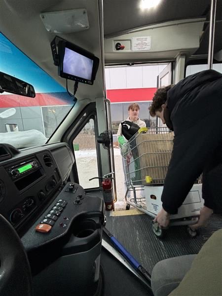 Dylan Russell and Graham Gard load the shuttle as the U18 Prep team prepares to deliver their Christmas Hampers.