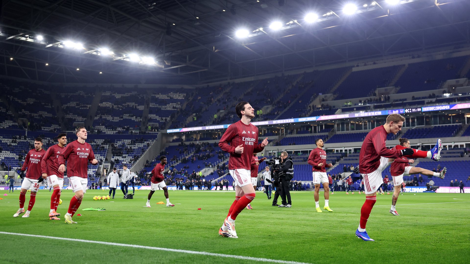 Arsenal players warming up at Hill Dickinson Stadium.