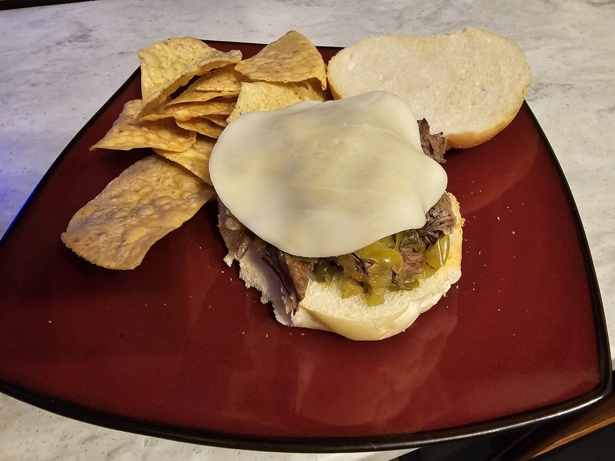 Crock Pot Italian Beef Sandwich w/ a slice of provolone and some tortilla chips. 

10 hours to make and it came out so good. 😋