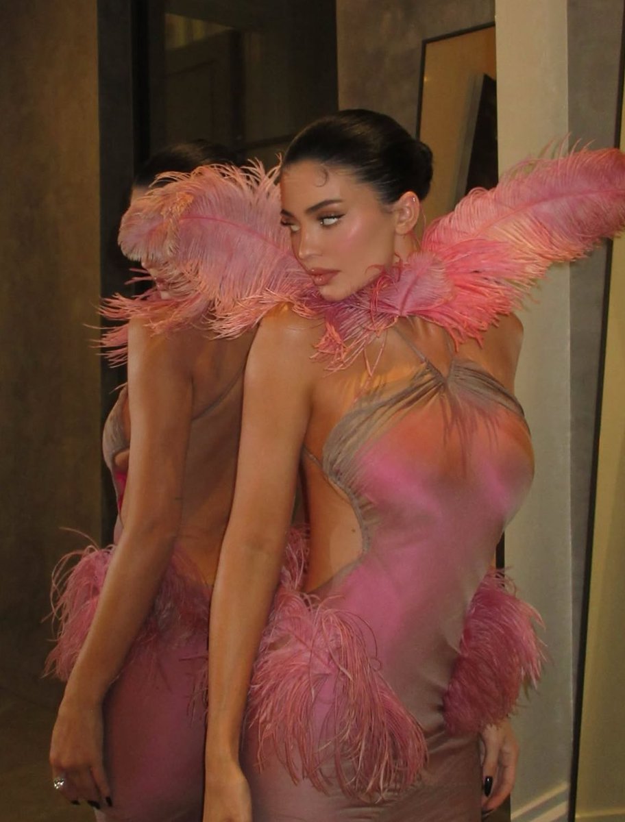 kylie jenner wearing conner ives ss26 feather pink dress