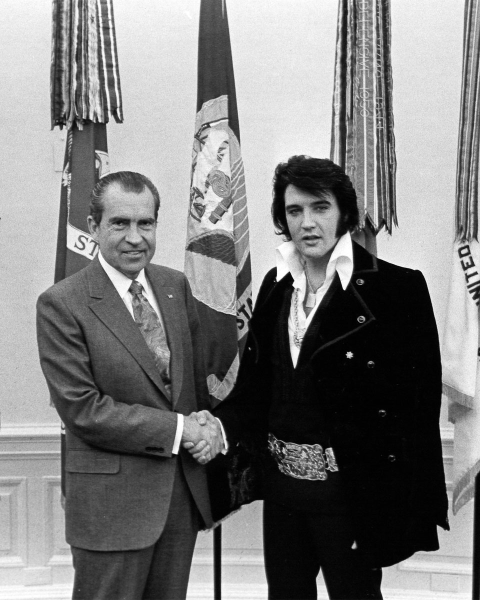 ElvisPresley's tweet image. On this day, Elvis Presley entered the Oval Office in a purple velvet suit, amber sunglasses and a large diamond-encrusted, gold-plated belt buckle. Nixon looked at Elvis and said, “You dress kind of wild, don’t you, son?” 

#ElvisPresley #Icon #OvalOffice #Outfit #Belt