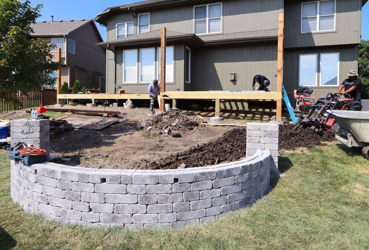 This Olathe backyard was reimagined with how the homeowners actually live in mind. A custom patio, deck, and fire pit with a retaining wall now give them a space to gather, relax, and enjoy every season—just the way they envisioned it.