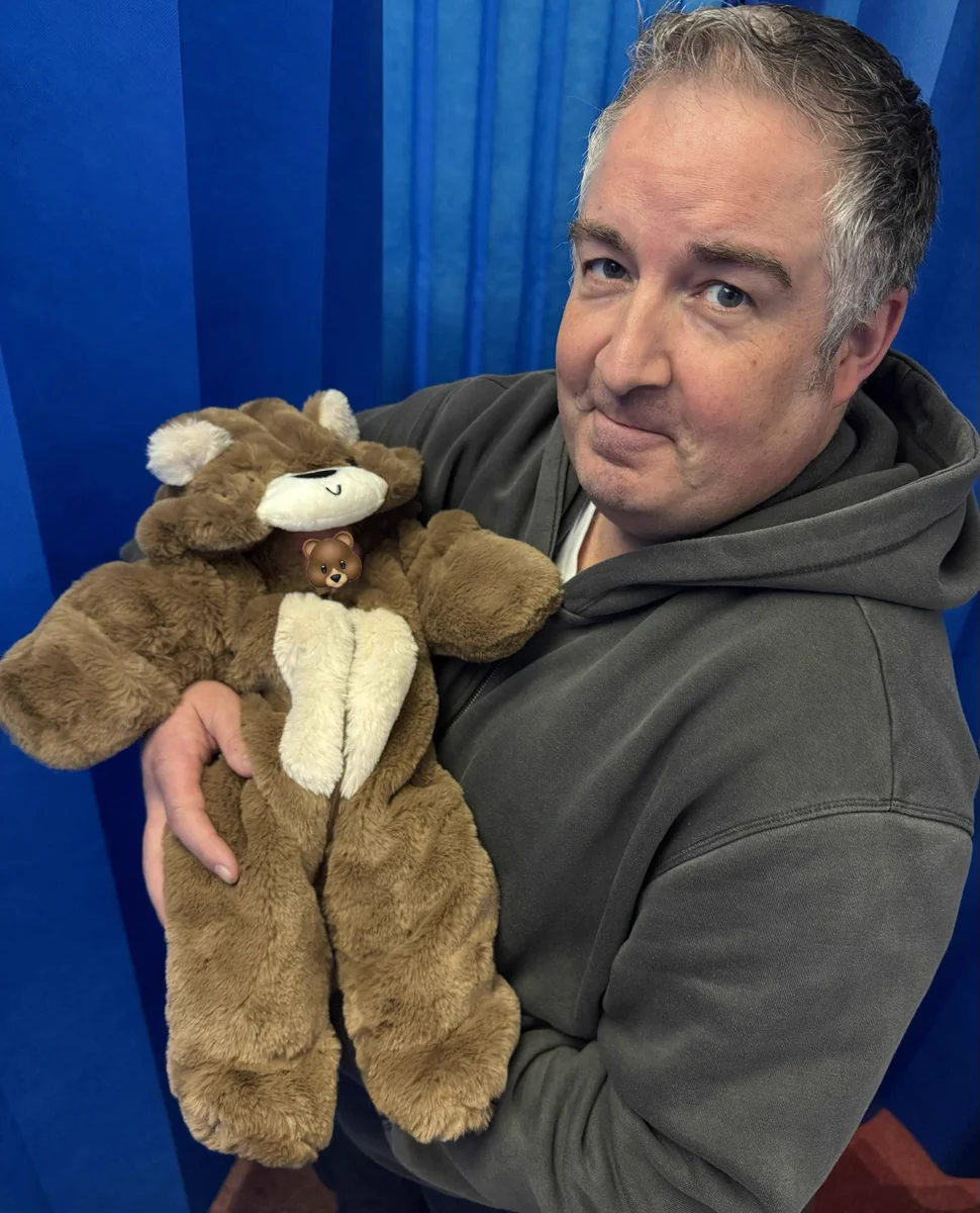 Me holding my beautiful new granddaughter dressed in a bear onesie (what else 😂)