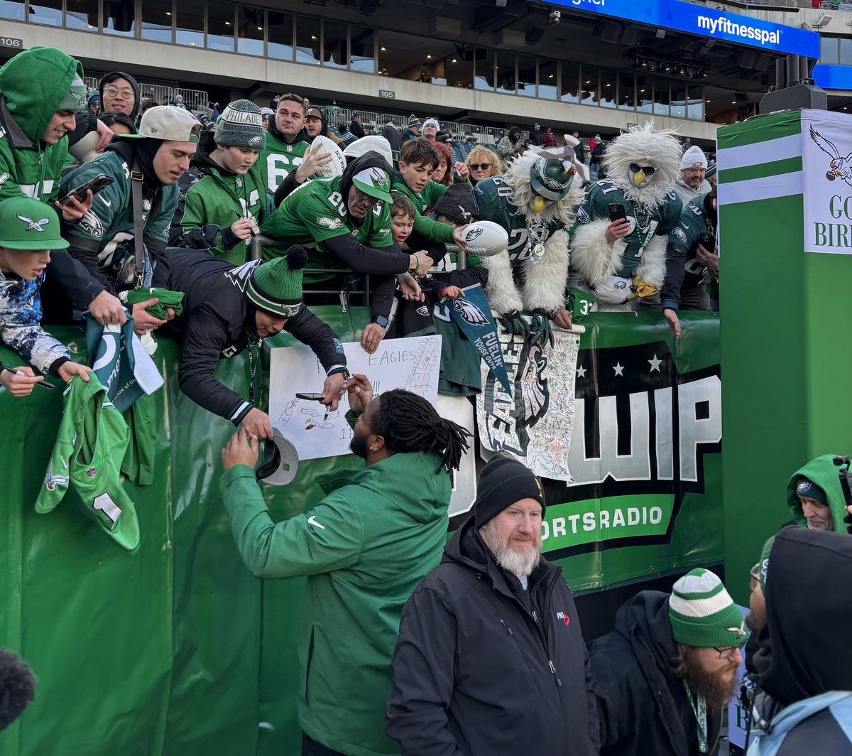 Cooper DeJean and Jalen Carter signing autographs for Eagles fans