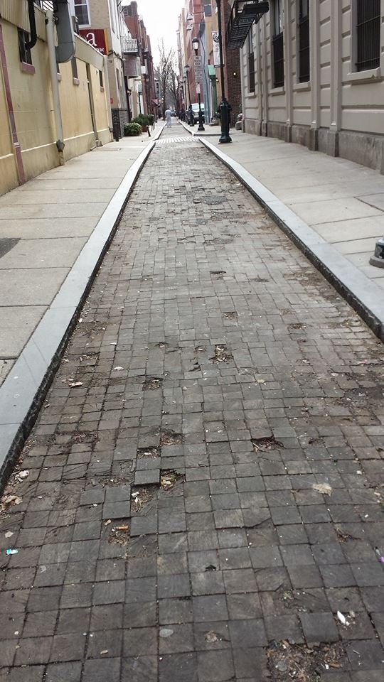 Took this 12 years ago while in Philly for NYE. It is the Camac street (maybe 200 block) which at the time was to only surviving street that was paved with wood. The wood paving deadened the sound of the horses waling on it.
 I think it has been paved over.