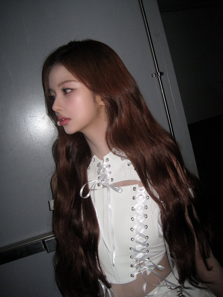 I stand quietly under the dim light, wrapped in white ribbons and laces, feeling like a delicate secret from a fairytale who exists softly, beautifully, and just for this moment.🕯️🤍