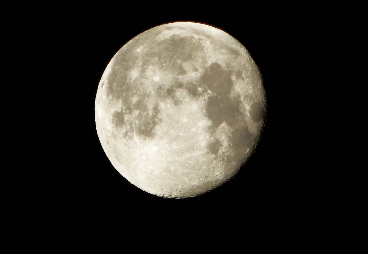 Scraping snow off the car his morning with the waning Wolf Moon watching down on me.
