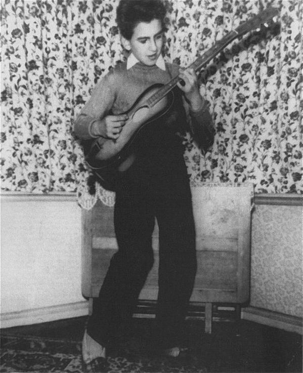 George Harrison at home with his first Egmond guitar in 1956.