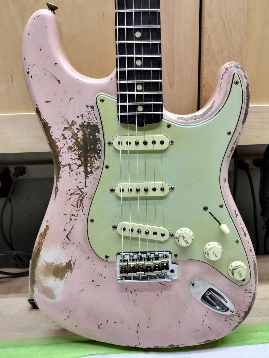 Fender's tweet image. We're loving this '62 Shell Pink Strat with a Brazilian rosewood fretboard Strat from Jason Smith headed to Rainbow Guitars. 🩷