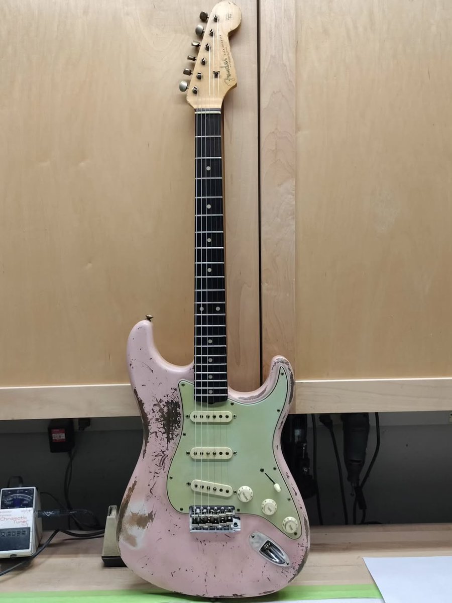 Fender's tweet image. We're loving this '62 Shell Pink Strat with a Brazilian rosewood fretboard Strat from Jason Smith headed to Rainbow Guitars. 🩷