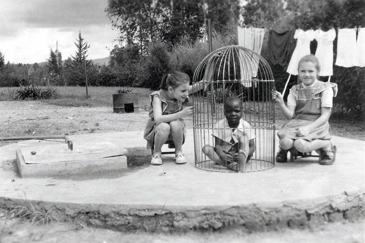 JIX5A's tweet image. Two white girls trapping a black boy in a bird cage, Belgian Congo ca. 1955

Using black people as pets to be white children’s playmates