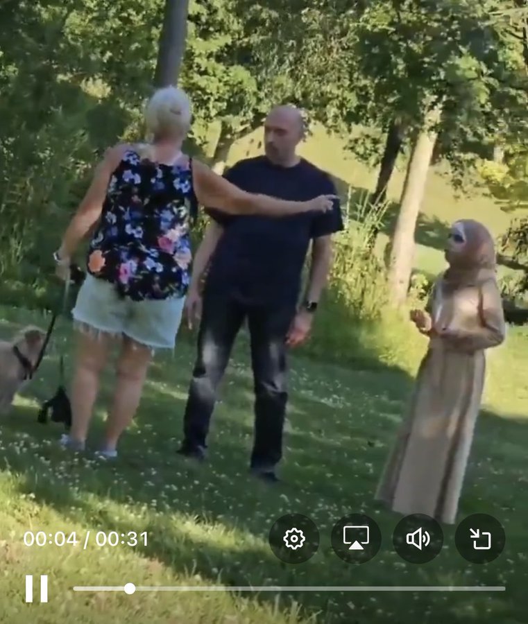 We would say (nicely), "In this country, having and loving dogs is normative culture. If it offends you, please stay inside or go live in a culture where you feel more comfortable. Because if our dogs make you unhappy, certainly other things in our society do as well."