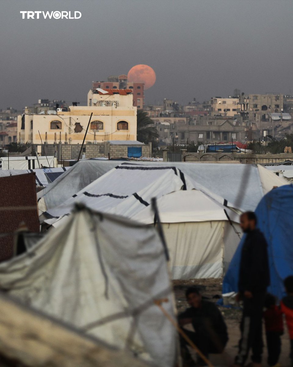KumariCr's tweet image. A full Wolf Moon shines over Gaza's rubble and displacement tents, highlighting the besieged Palestinian territory under Israeli blockade and ongoing violations causing over 400 deaths since October 10.