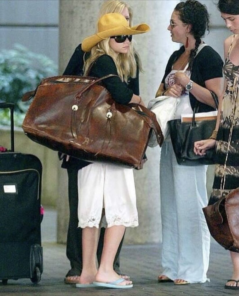 BagelCentral's tweet photo. the Olsen twins and a ludicrously capacious bag https://t.co/es0V9V3G79