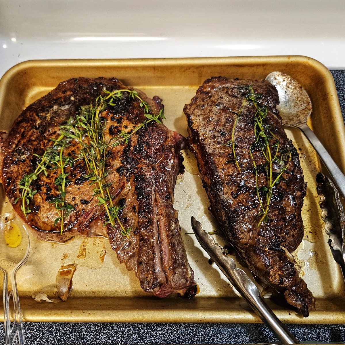Cast iron skillet steak for Christmas dinner! Ribeye on the left, NY Strip on the right. The strip is for tomorrow night's dinner of steak Caesar salad.
