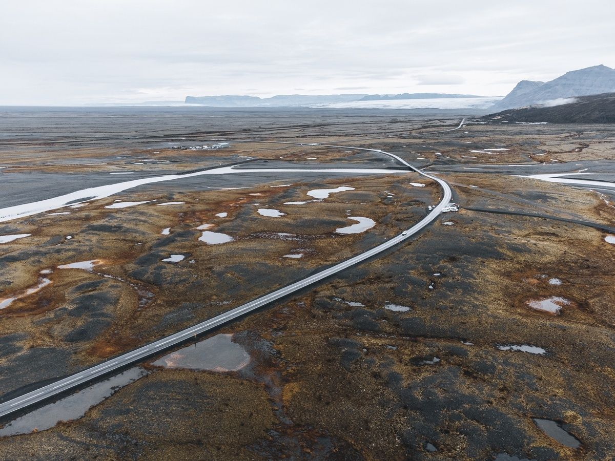 jamesonabart's tweet photo. A ribbon of road into the expanse — quiet, endless, and full of promise. 

#reflection #Iceland https://t.co/u93gOdH4DM