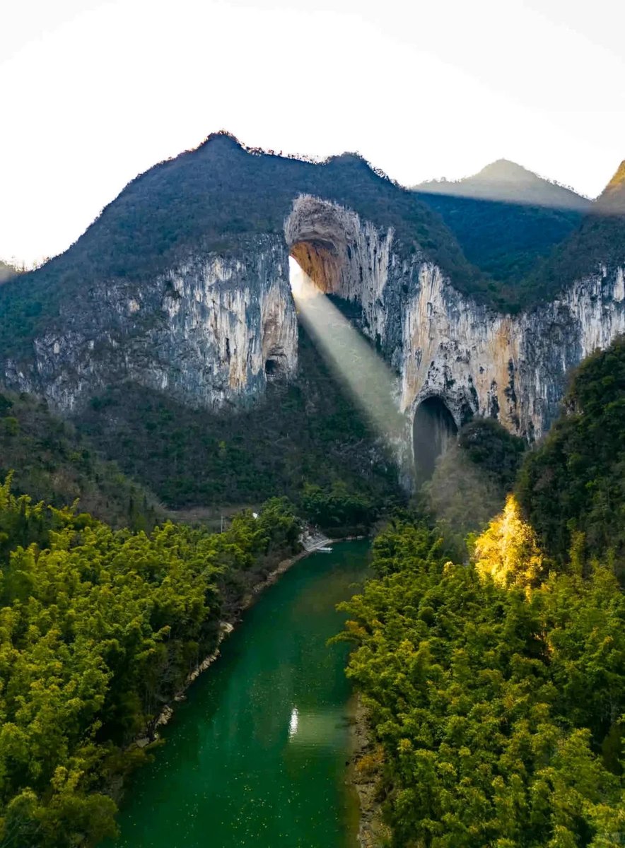 amazingguizhou2's tweet photo. 💧🪨Getu River: A Beam of Light, Ancient Caves, Hearing the Earth’s Heartbeat

In the karst wonderland of the Getu River, the meeting of light and caves creates a miracle. When sunlight pierces through the hundred-meter-high dome of Swallow Cave, a beam of “divine light” descends as promised, while tens of thousands of rock swallows dance in the golden glow. Drifting along the river, you will encounter the best-preserved ancient river channel on Earth—the Blind Valley, where 300-meter-deep cliffs encircle the silence of primordial times.

This is also a land of echoes. Whisper in Echo Valley, and the mountains will respond clearly, like an intimate conversation between heaven and earth. A French geomorphologist once called this place “one of the most beautiful in the world.” Perhaps what he heard was the timeless, serene yet majestic heartbeat of this land.

📸Image source: @寻迹旅游旅行社 from RedNote

#AmazingGuizhou #GetuRiver #HiddenGemOfGuizhou #KarstWonders #LightOfTheEarth #PhotographyParadise