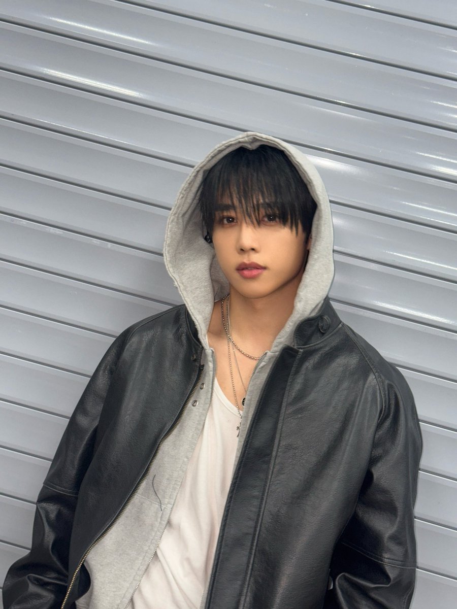 Hood up under leather layers, silver chains catching quiet light. Soft fabric, hard edges effortless rapper boyfriend energy.