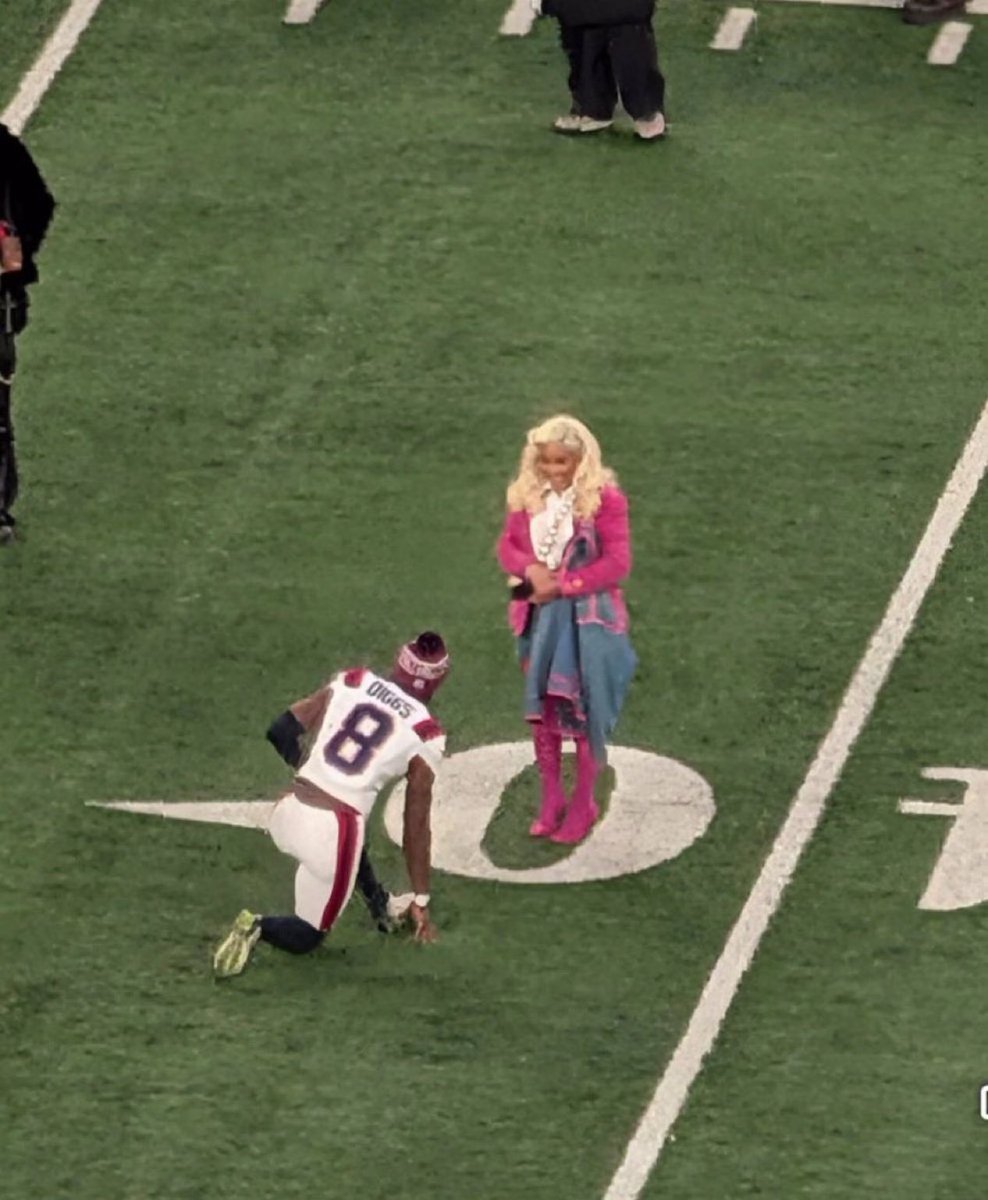 Stefon Diggs on the field with Cardi B after the Patriots win 🩷