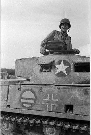 The circle with horizontal bars is a U.S. tactical or unit identification marking, commonly added by American forces to identify captured vehicles, avoid friendly fire, and mark vehicles used for testing, training, or transport after capture.