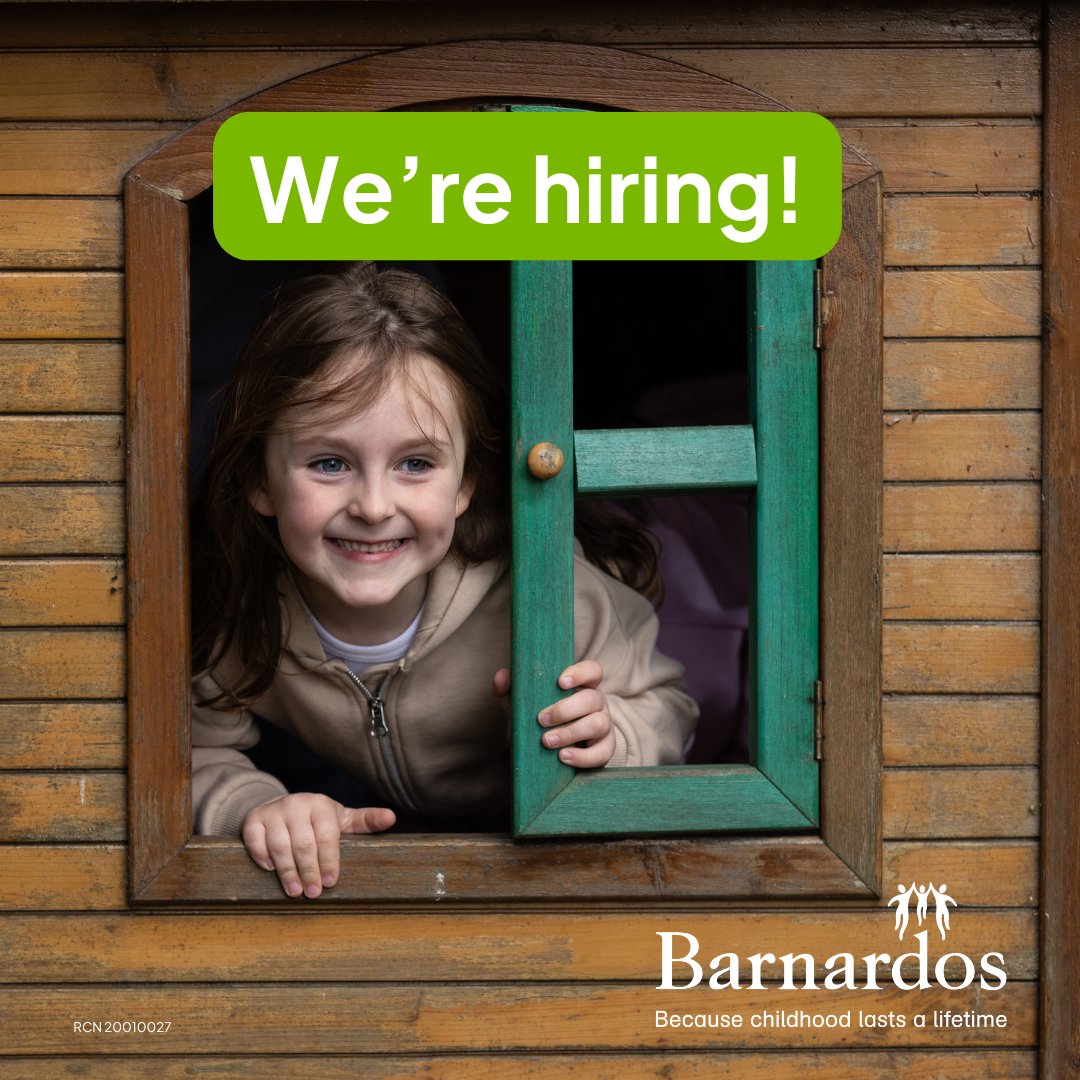 Child peeking through a green wooden window of a rustic cabin with a 'We're hiring!' sign above.