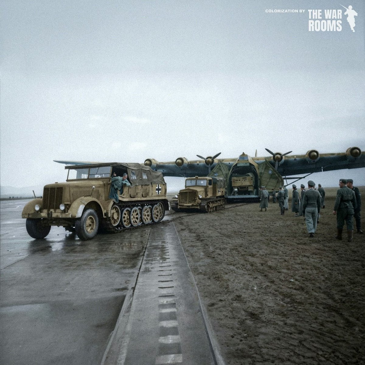 A Messerschmitt Me 323 Gigant being towed by German half-tracks and tractors on a Tunisian airfield, December 1942.