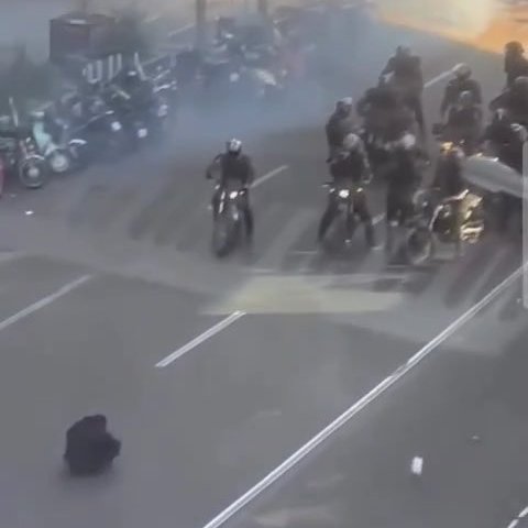 visegrad24's tweet image. An Iranian anti-regime protester sat in the middle of a street in Tehran, refusing to move as motorcycle-riding security forces advanced on demonstrators.