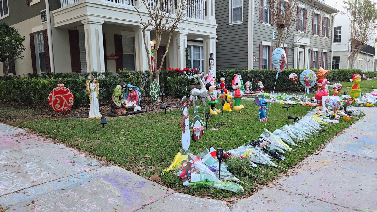 A growing memorial outside the home of Adam The Woo. The Central Florida theme park community has been paying tribute to the vlogger since his death. Fans have left flowers, Starbucks cups, and heartfelt messages.