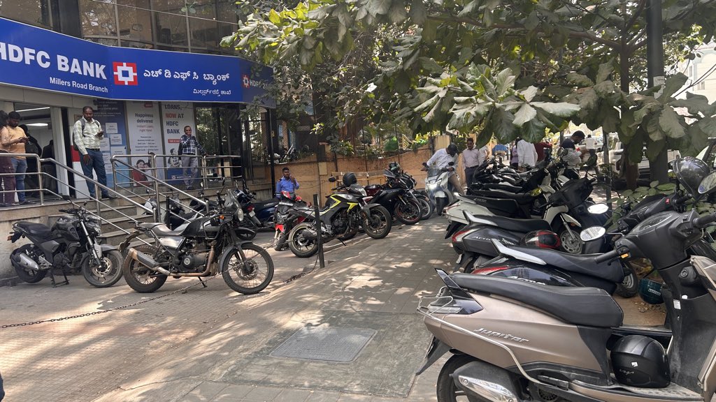 rajthesaviour's tweet photo. @highgroundtrfps  
Img of bikes parked on footpath in front of @HDFC_Bank Millers Rd. Peds can't walk; slope makes it tough for elderly. Next to @ManipalHealth Millers Rd. Pls address ASAP. https://t.co/7eLcGhvWS3